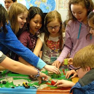 students in elementary classroom working activity