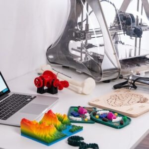 3d printer with objects and laptop
